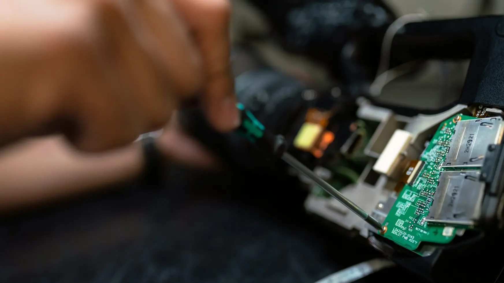 DTF person holding green and black circuit board